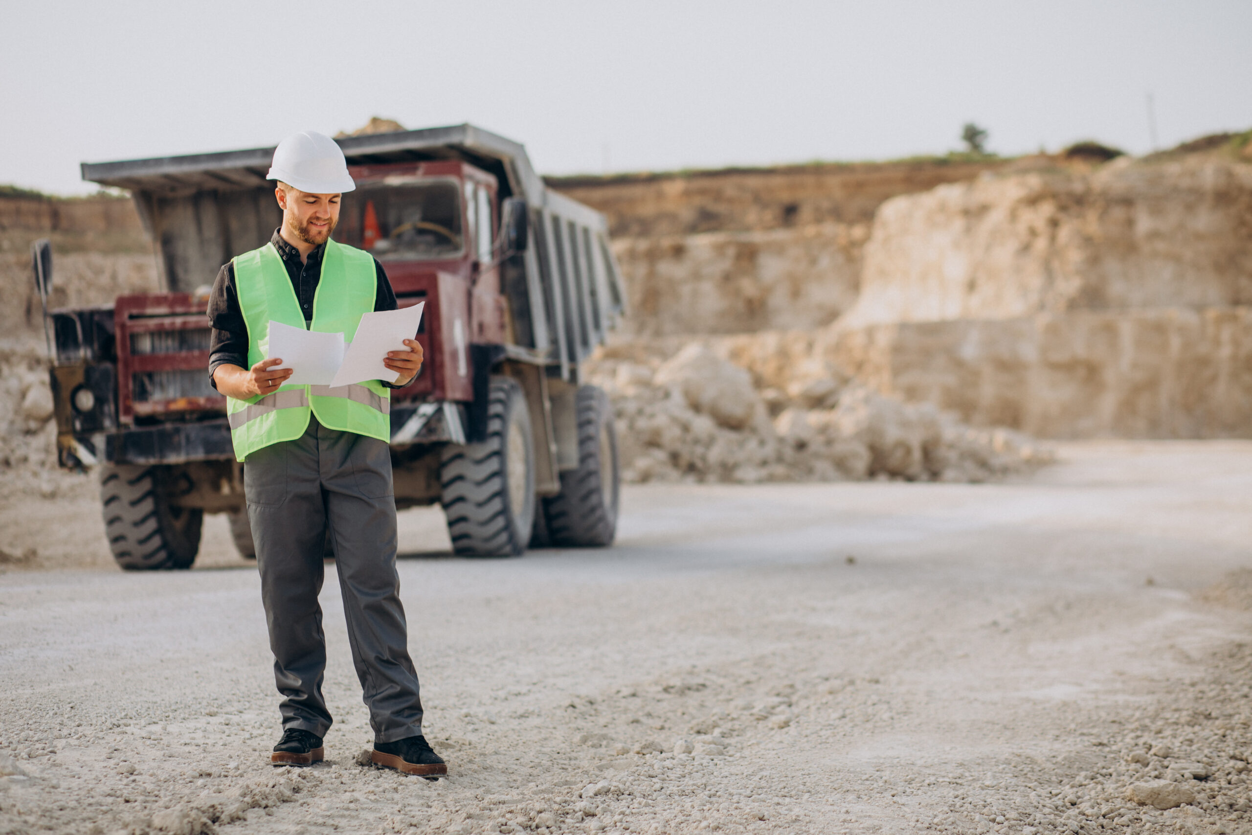 Male worker with bulldozer sand quarry scaled